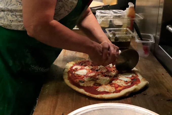 Chef preparing fresh pizza in the James Peak Pizza kitchen